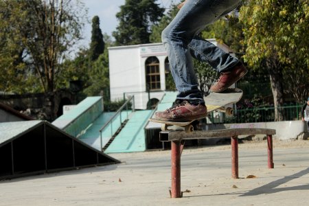 person skating on rail during daytime photo