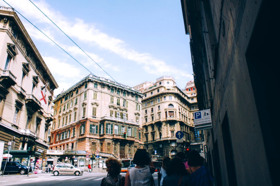 people at the street surrounded with buildings during daytime photo