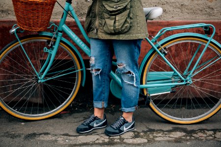 person standing beside bike photo