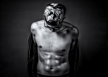 grayscale photo of man with face paint