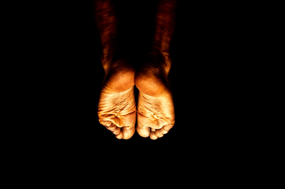 persons feet on black background