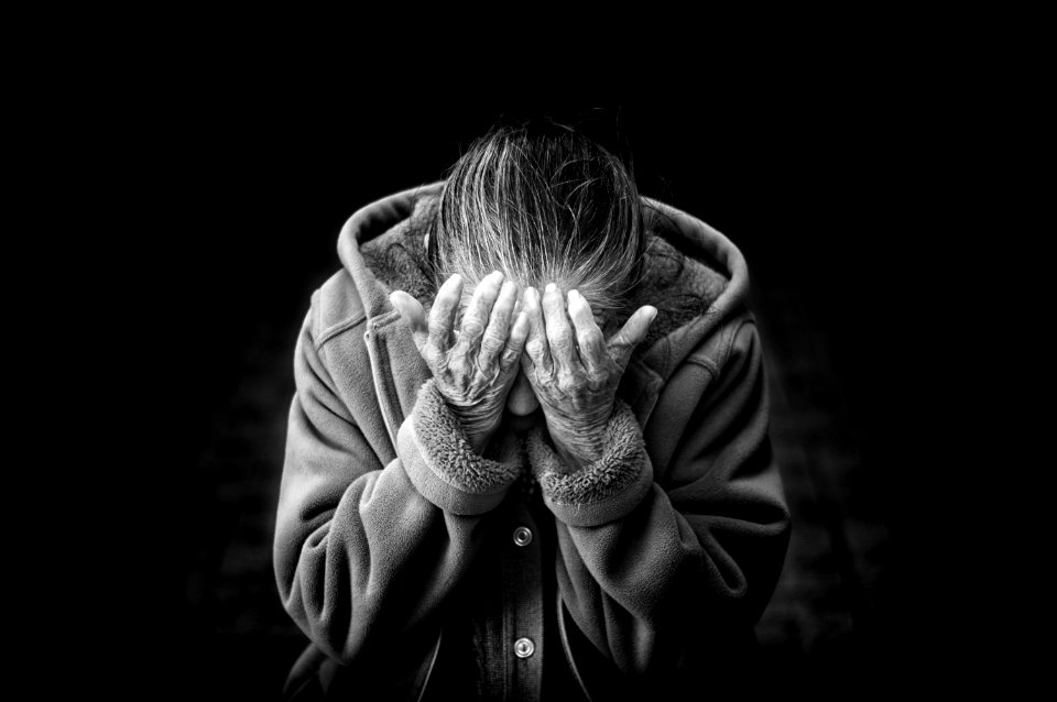 grayscale photography of person covering face