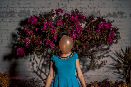 woman standing in front of brown balloon photo