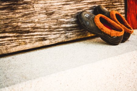 pair of black moccasins shoes leaning on wall photo