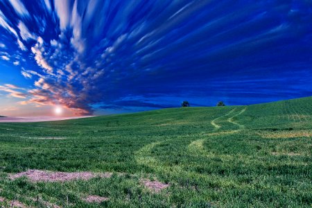 time lapse photography of green field and clouds photo