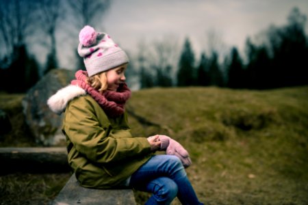 smiling girl sitting on brown bench