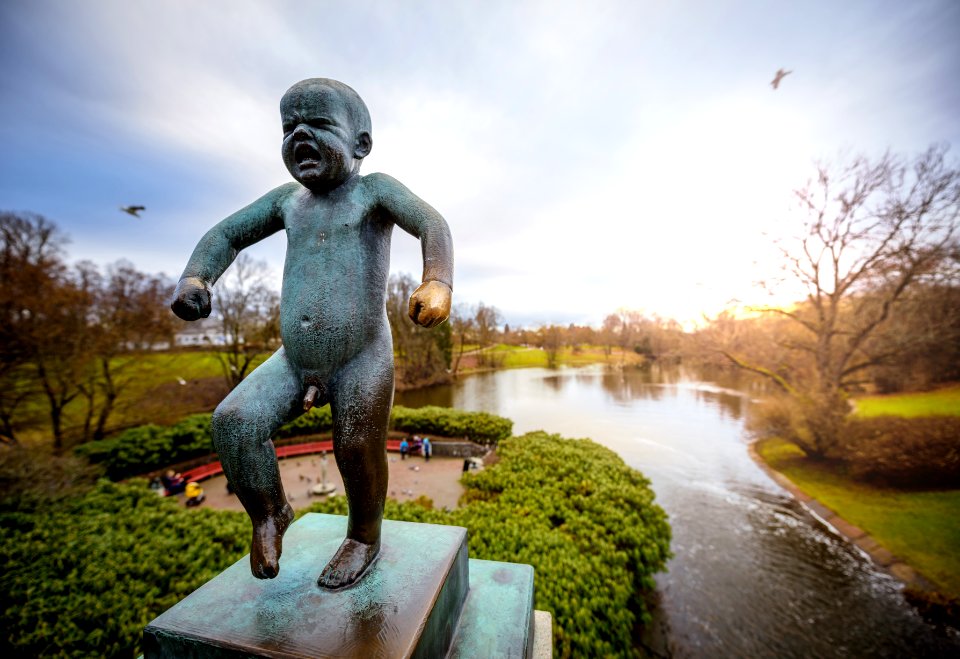 gray concrete statue near body of water during daytime