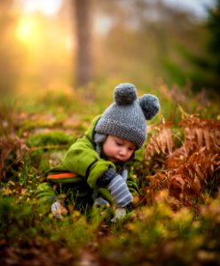 selective focus photo of baby on green grass field photo