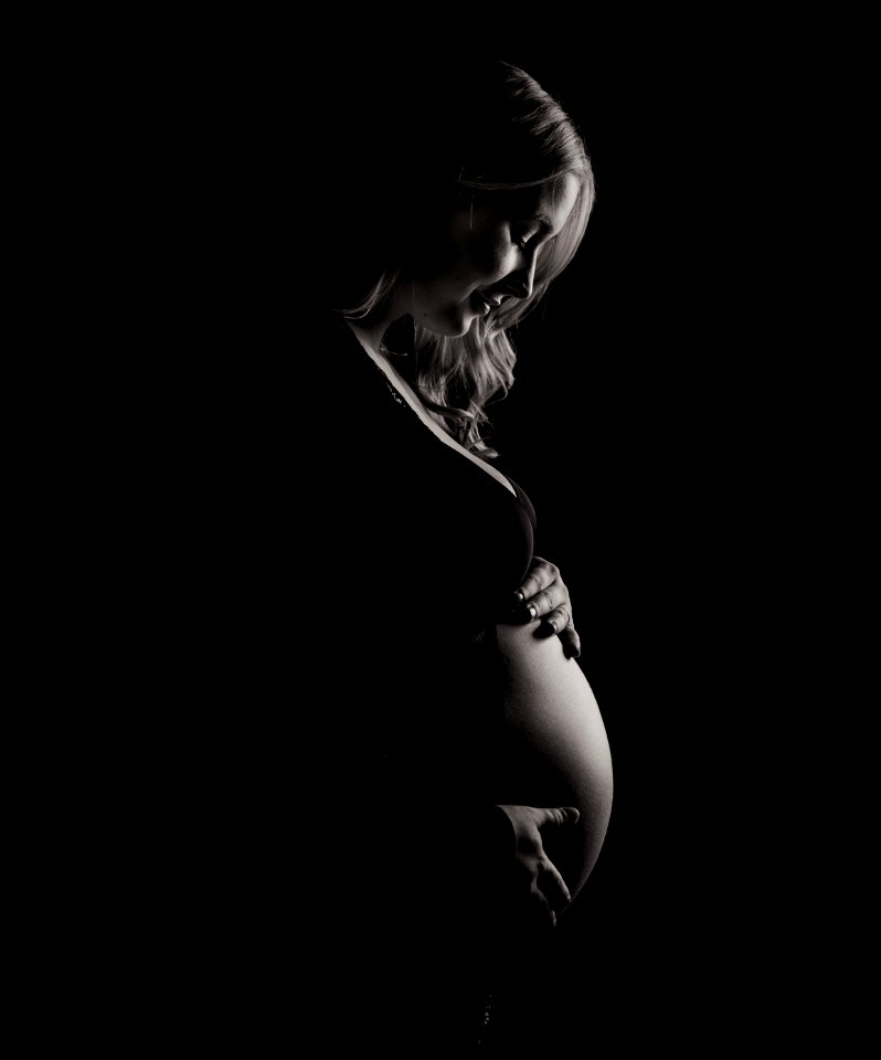 pregnant woman holding tummy