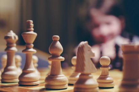 beige chess piece on board in selective focus photography photo