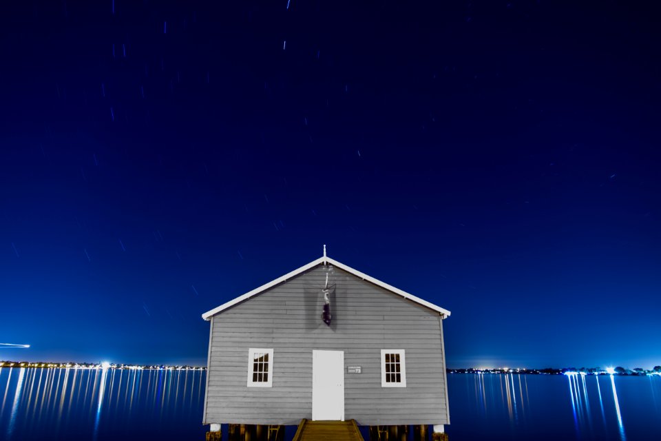 gray house surrounded with body of water photo
