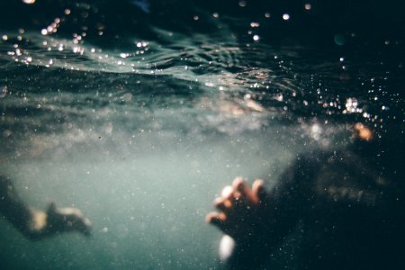 underwater photo of person wearing black shirt photo