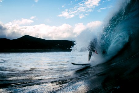 surfer surfing on tidal wave photo