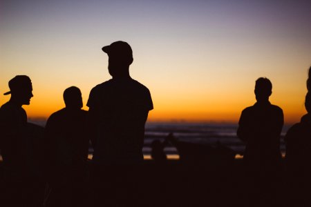 silhouette group of people under sunset photo