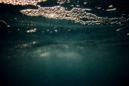 water with bubbles floating underwater photo
