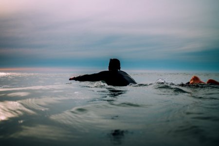 man wearing black shirt on body of water photo
