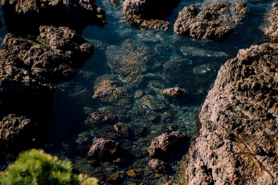 rocks in body of water at daytime