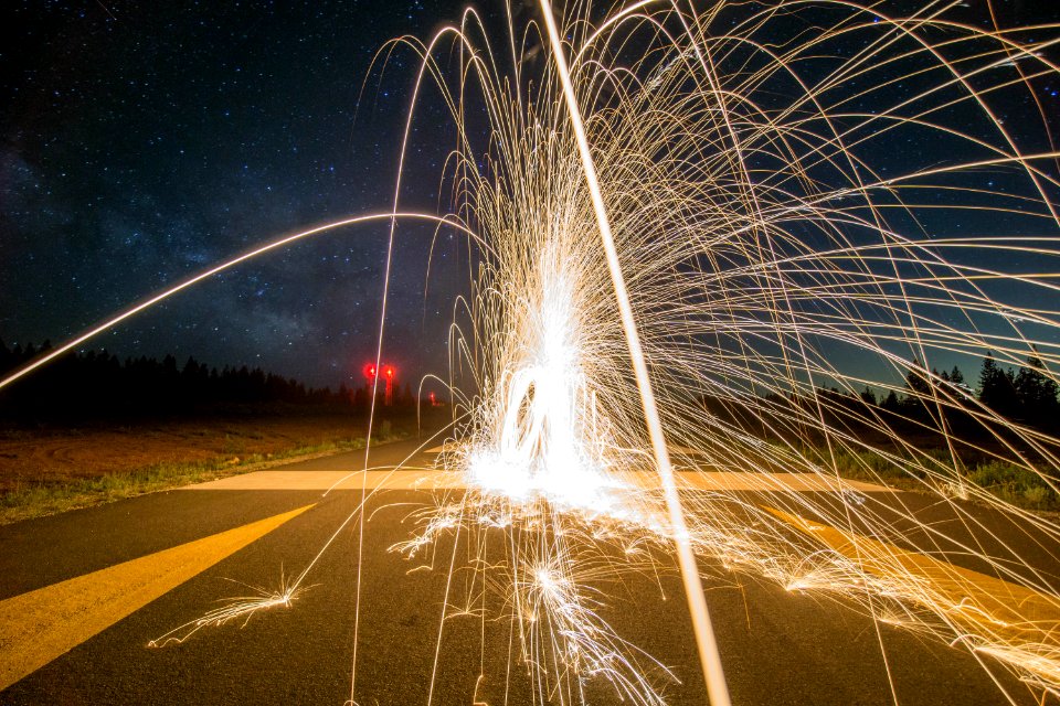 time lapse of firecracker on gray concrete road during nightitme