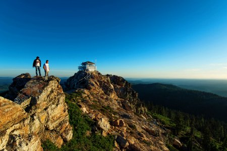 two men standing on rock formation