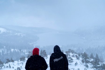 two people sitting on hills photo