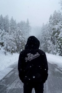 person wearing black hooded jacket photo