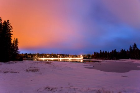 lit streetlights near body of water during nighttime photo