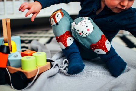 baby boy wearing pair of blue socks photo