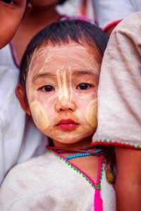 child with beige face paint photo