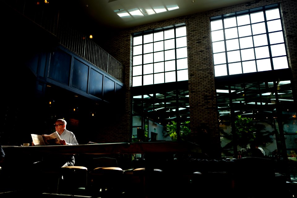 Man sitting and reading the newspaper.