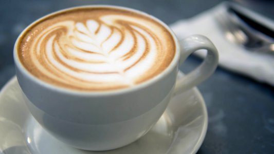coffee latte in white ceramic mug photo