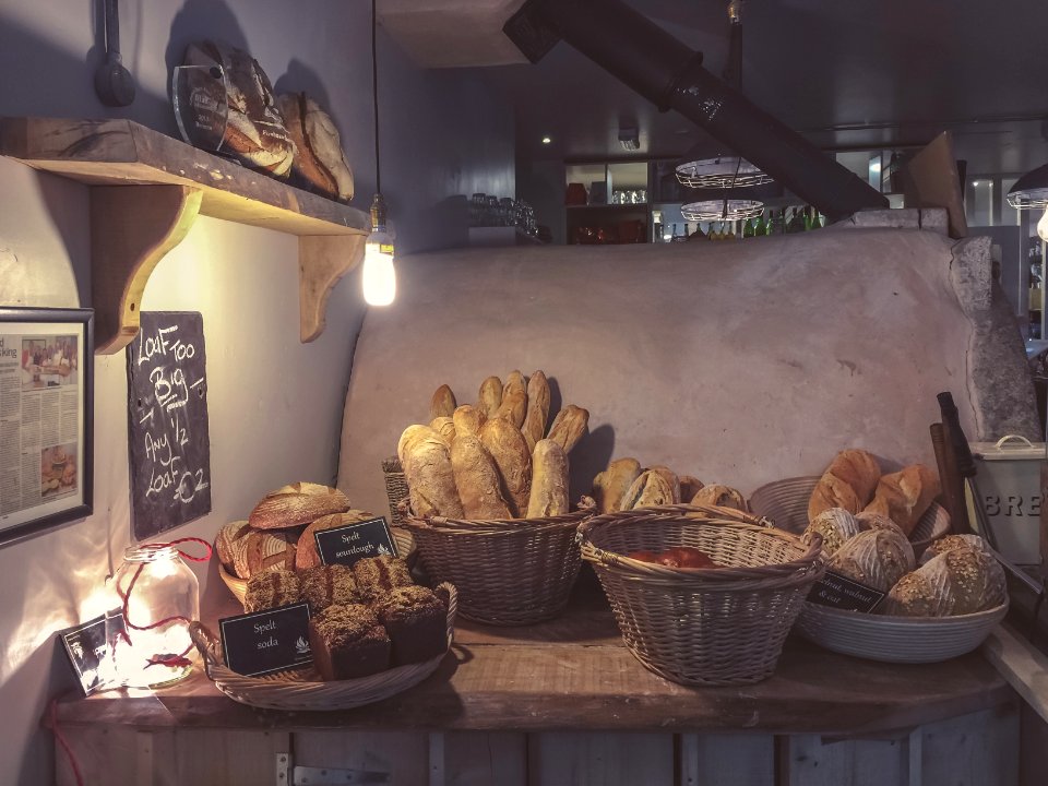 breads in brown wicker basket on top of brown wooden table photo