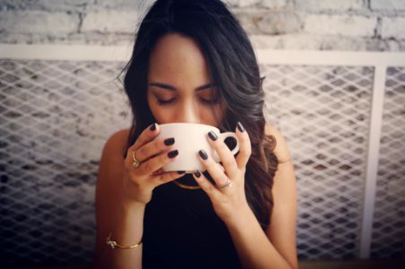 woman drinking with cup photo