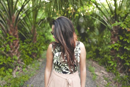 woman walking on forest trail looking downwards