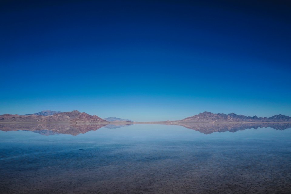 body of water and mountains during daytime
