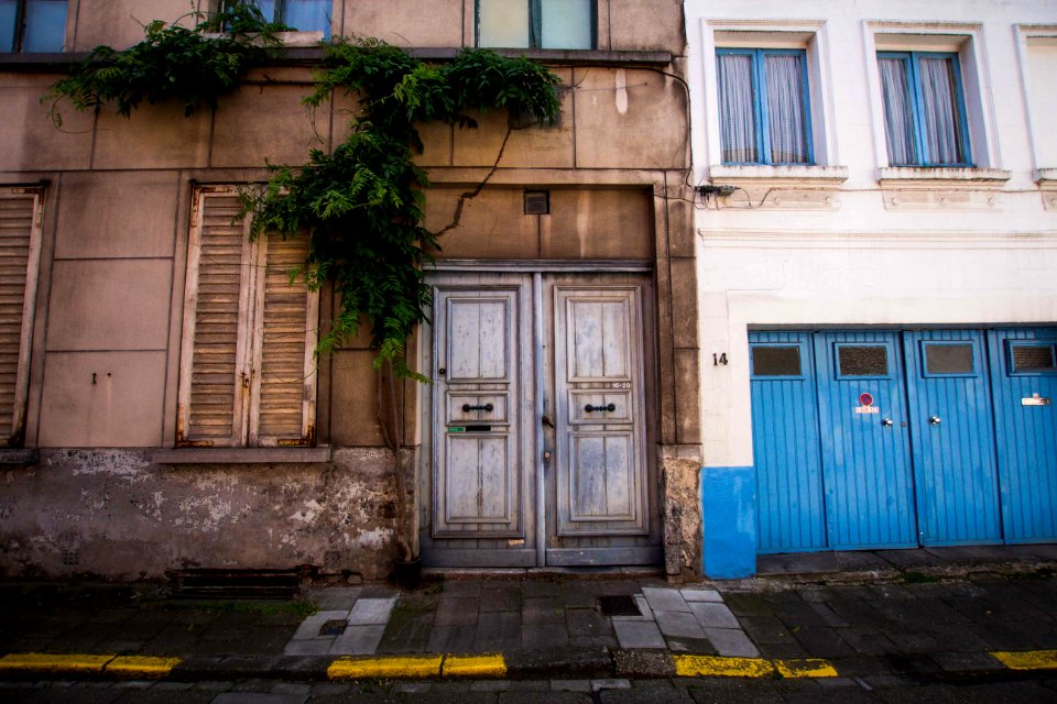 closed gray two-doors of brown concrete building
