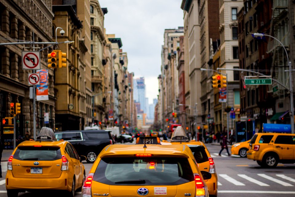 yellow cab in between of building