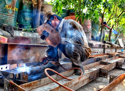man using welding machine photo