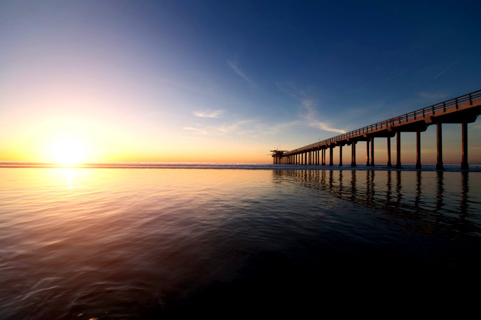 brown wooden dock under clear blue sky during daytime