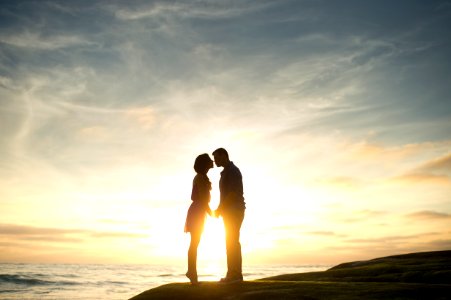 silhouette of man and woman about to kiss photo