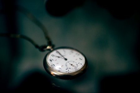 lowlight photography of white pocket watch