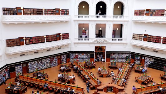 aerial photography of people reading books inside library