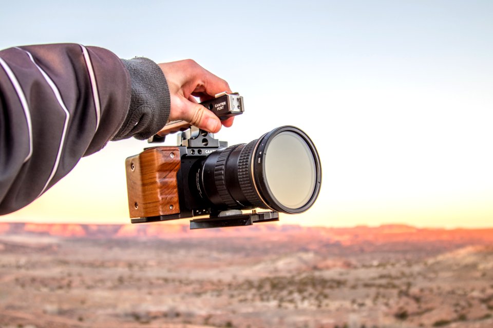 person holding black DSLR camera