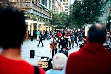 man playing guitar while singing photo