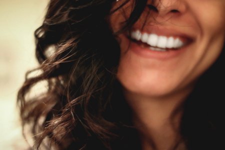 long black haired woman smiling close-up photography photo