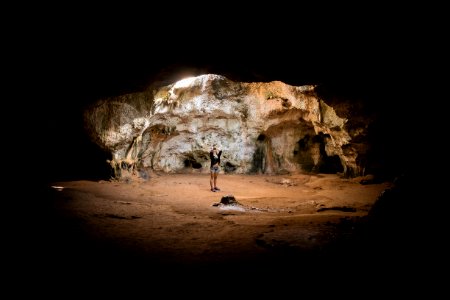 person standing in cave photo