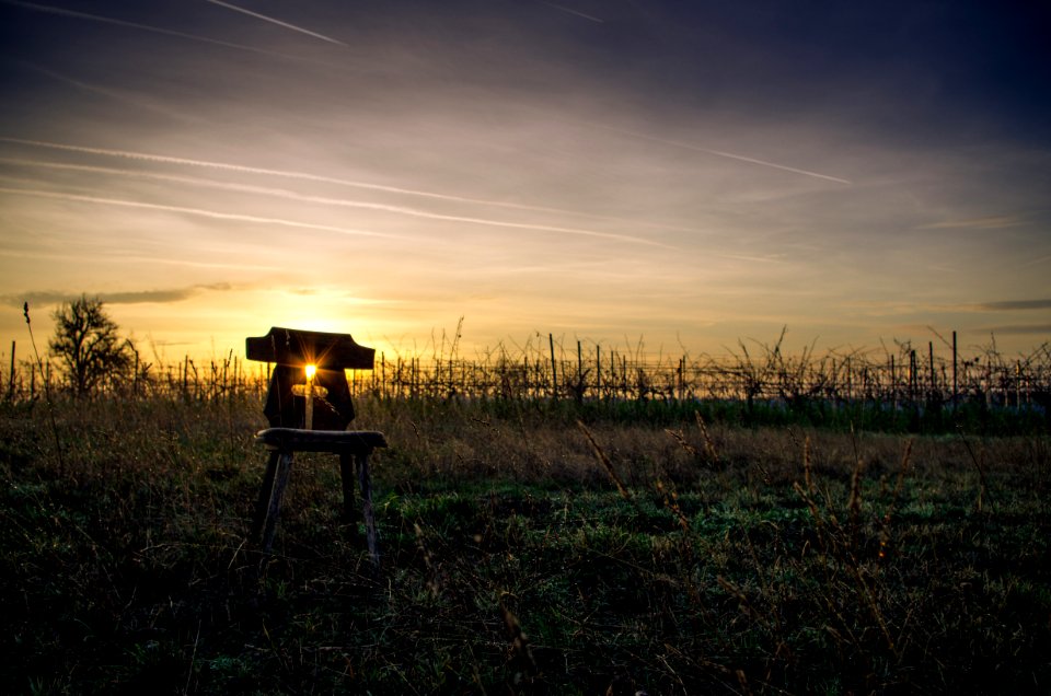 silhouette of a person sitting on a chair during sunset