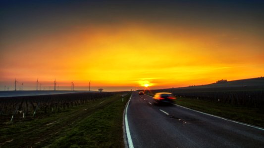 black car on road during sunset