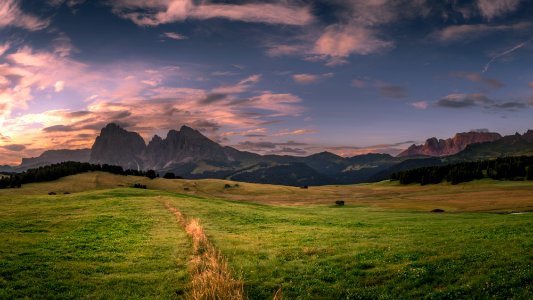 landscape photo of field under cloudy sky during daytime photo