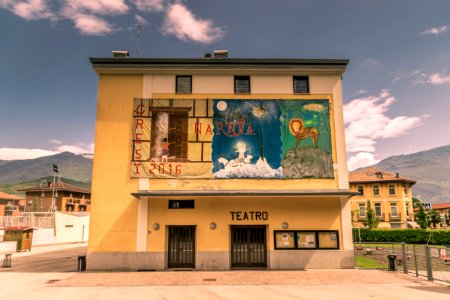 white concrete building with horse and horse painting photo