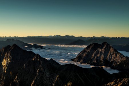 mountains surrounded with clouds in horizon photo